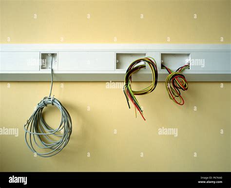 Electrical Wires Hanging Out On A Wall Stock Photo Alamy
