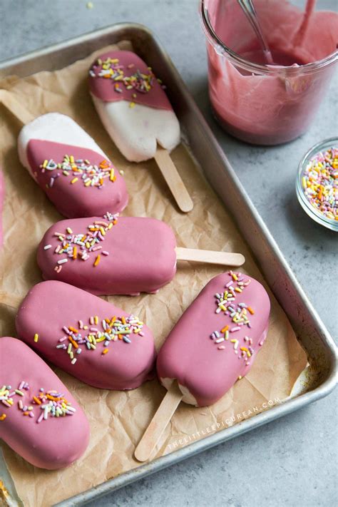 pink ice cream pops with sprinkles on a tray