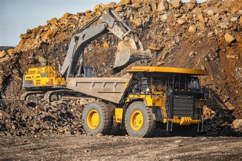 Open Pit Mine Industry Excavator Loading Coal On Big Yellow Mining