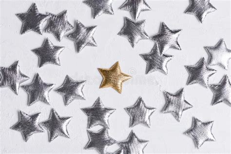 Shiny Golden Star In Center Of Silver Stars On White Background Stock