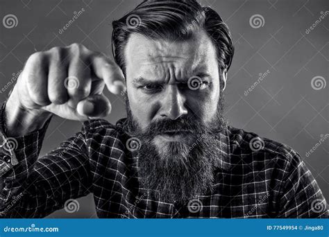 Closeup Portrait Of An Angry Bearded Man Threatening With His Fist
