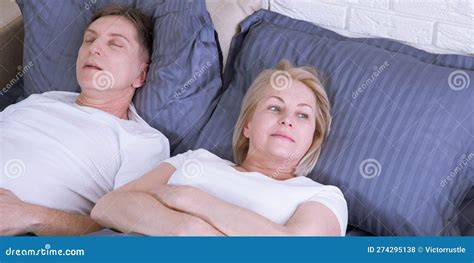 snoring man couple in bed man snoring and woman can not sleep middle age couple in bed at