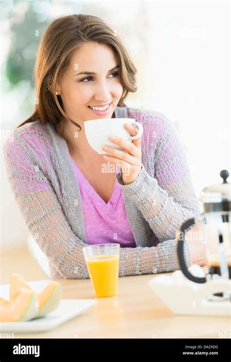 Young Woman Drinking Tea At Table Stock Photo Alamy
