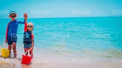 Happy Kids Play On Beach Boy And Girl Hands Up At Sea Stock Photo