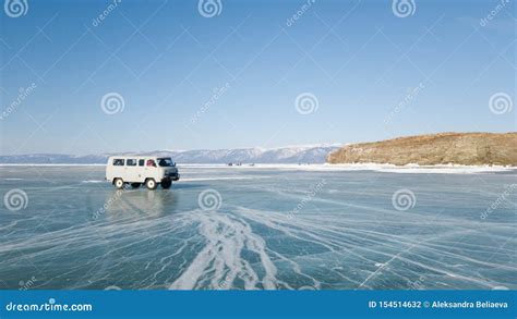 An Old Excursion Off Road Bus Rides On The Ice Of The Frozen Lake