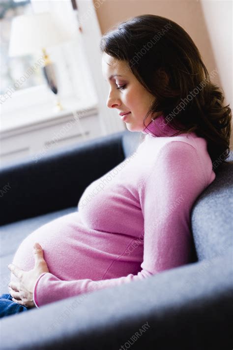 Pregnant Woman Sitting On Couch Stock Image F0032187 Science Photo Library