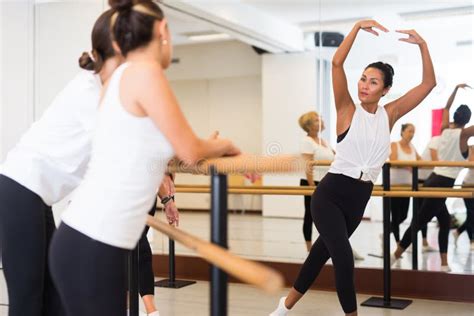 Ballet Teacher Demonstrates Dance Moves To Students Of School Stock