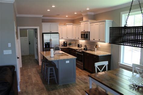 Kitchen With White Painted Upper Cabinets Stained Lower Cabinets And