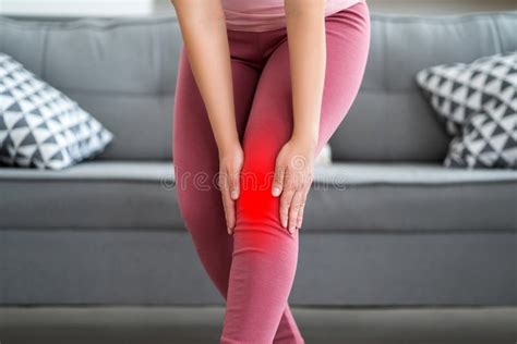 Knee Pain Woman Suffering From Ache And Doing Self Massage At Home