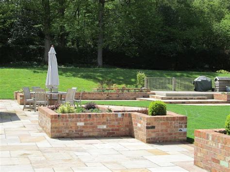 Garden With Reclaimed Brick Planters Steps And Indian Sandstone Paving