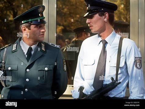 police officers of west r and east l berlin chat at the german unification day in berlin