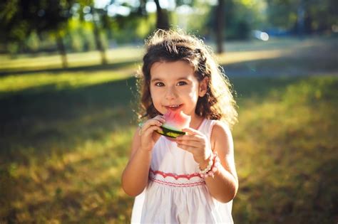 Premium Photo Funny Kid Eating Watermelon Outdoors In Summer Park
