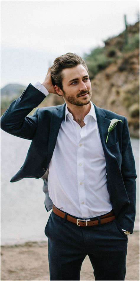 And yet, some attire are more popular than others. Chic groom attire, navy blue suit, white calla lily bout ...