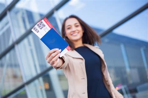 Premium Photo Travel Closeup Of Girl Holding Passports And Boarding Pass At Airport