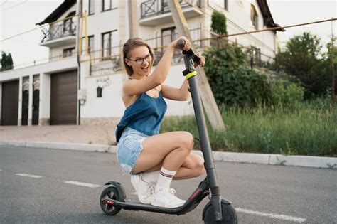 Free Photo Young Beautiful Girl Riding An Electric Scooter In The Summer On The Street