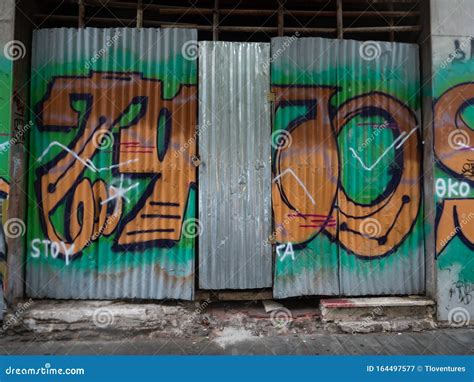 Spray Painted Graffiti On A Corrugated Metal Door Editorial Photography
