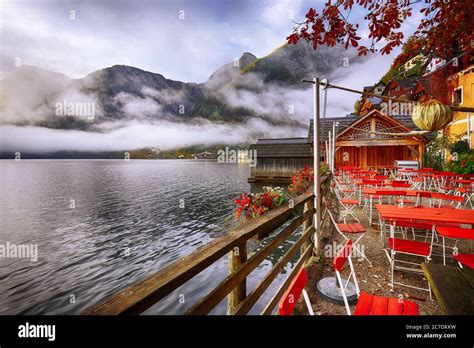 Scenic View Of Famous Hallstatter Lake Foggy Autumn Sunrise At Small