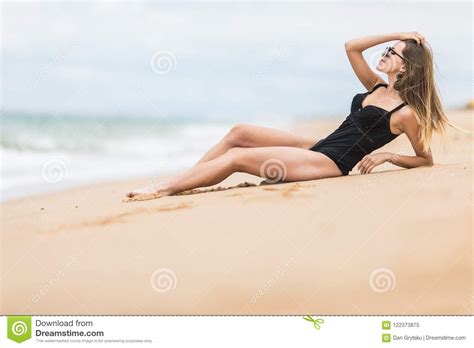 Beautiful Young Woman With Perfect Body Lying Down On The Beach