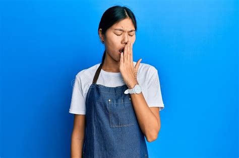 Young Chinese Woman Wearing Waiter Apron Bored Yawning Tired Covering