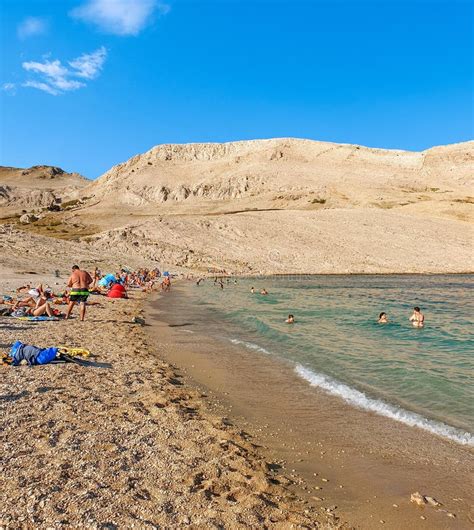 People On Amazing Sandy Beach Surrounded By Rocky Hills Rucica Beach On Pag Island In Croatia