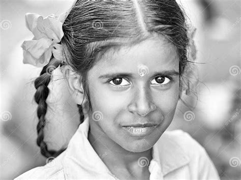 An Unidentified Poor Girl In A Small Village Looking At The Camera