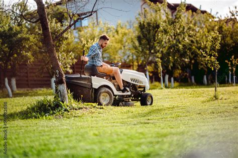 Industry Details Portrait Of Gardener Mowing Lawn Cutting Grass In