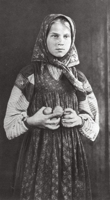 russian peasant girl with a plate of strawberries in a village near the sheksna river tributary