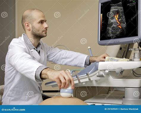 Portrait Of Young Male Technician Operating Ultrasound Machine Stock