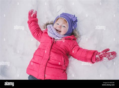 Young Girl Making Snow Angel In Snow Close Up Stock Photo Alamy