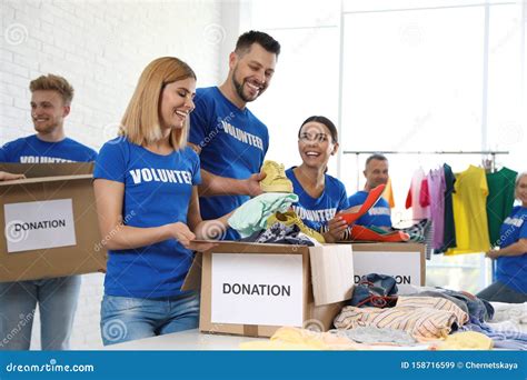 Team Of Volunteers Collecting Donations In Boxes Stock Image Image Of