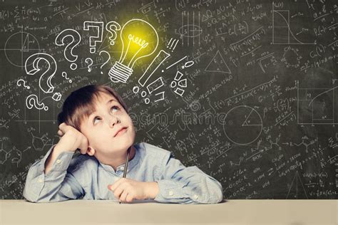 Idea Smart Kid Student With Lightbulb On Blackboard Stock Photo