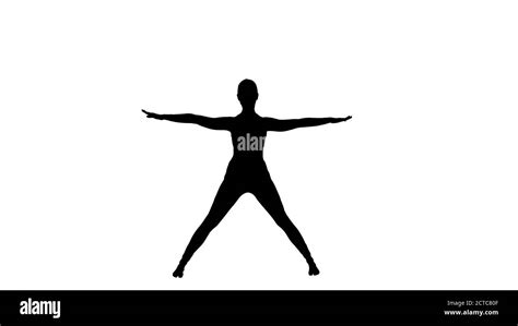 Silhouette Young Woman In Forward Bending Asana Yoga Pose Stock Photo