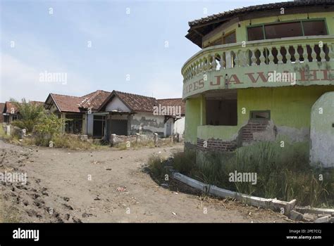 abandoned village in dried mud after mud volcano flooded by mud lake environmental disaster