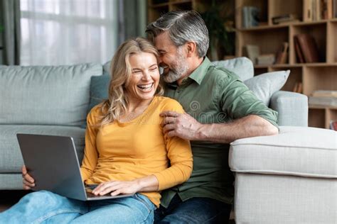 Happy Moments Romantic Middle Aged Spouses Using Laptop And Bonding At