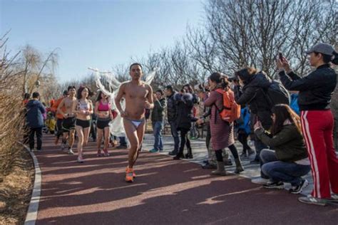bikini clad participant becomes centre of attention at beijing s annual naked run