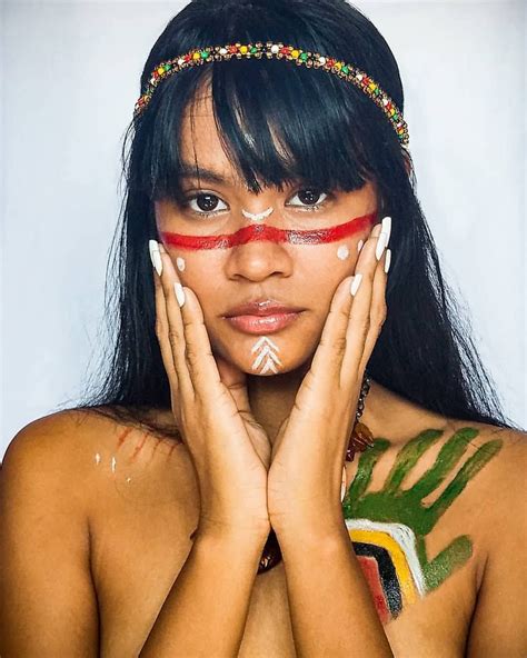 A Woman With Painted Hands Holding Her Face In Front Of Her Chest And Hand On Her Cheek
