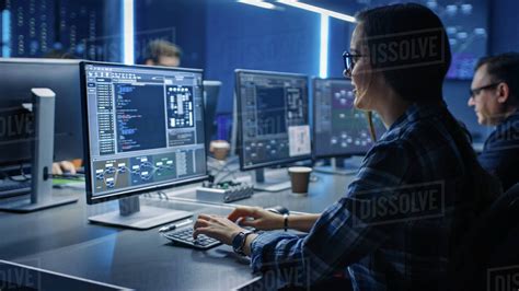 Smart Female It Programer Working On Desktop Computer In Data Center