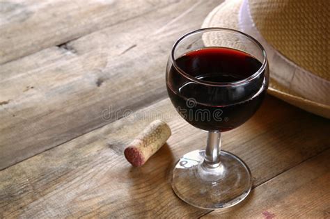 Red Wine Glass Wooden Table At Sunset Burst Vintage Filtered Image