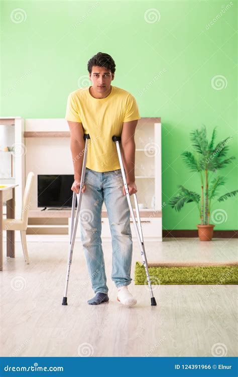 The Young Man Recovering After Accident At Home With Crutches Stock