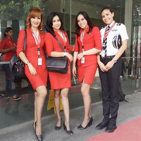 Three Women In Red Uniforms Are Posing For The Camera While Another