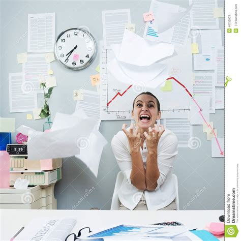 Angry Businesswoman Throwing Paperwork In Air Stock Photo