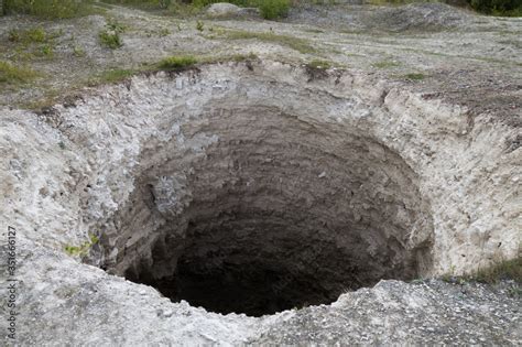 Black Aperture Of Karst Sinkhole Formed Above Abandoned Limestone Mine