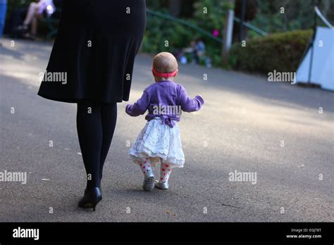 Mother And Female Toddler Walking Stock Photo Alamy