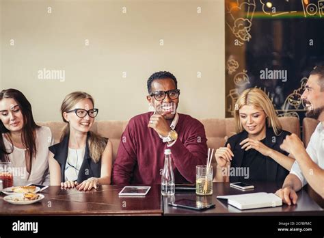 Group Of Happy Business People Eating Together In Restaurant Stock
