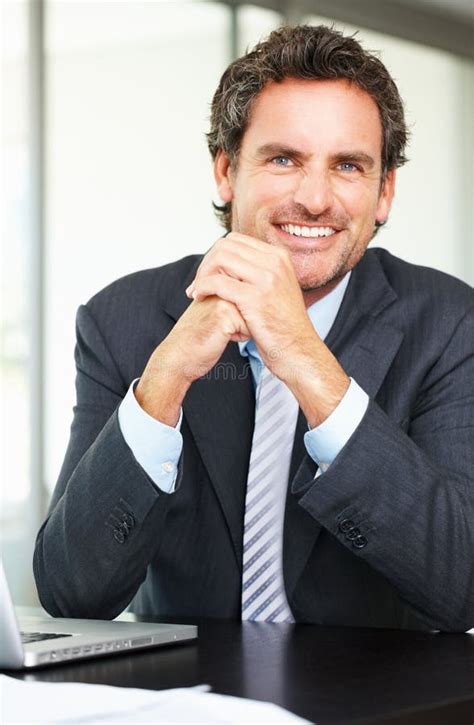 Business Man With An Attractive Smile Portrait Of Business Man Sitting
