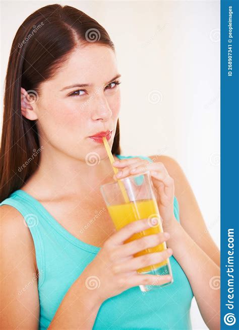 Enjoying A Fresh Glass Of Orange Juice Portrait Of A Beautiful Young