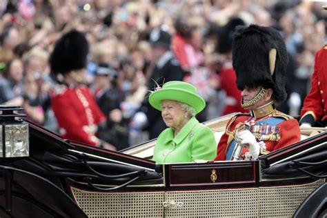 About 1,400 soldiers in ceremonial scarlet coats and bearskin hats marched past the queen in a ceremony on horse guards. Queen Elizabeth II celebrates her 91st birthday with ...