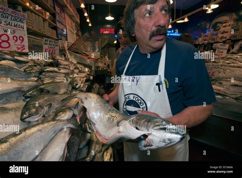 Fishmongers Sell Seafood At The Pike Place Market In Downtown Seattle