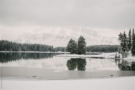 Winter Mountain And Forest Reflection On Calm Lake Water At Two Jack
