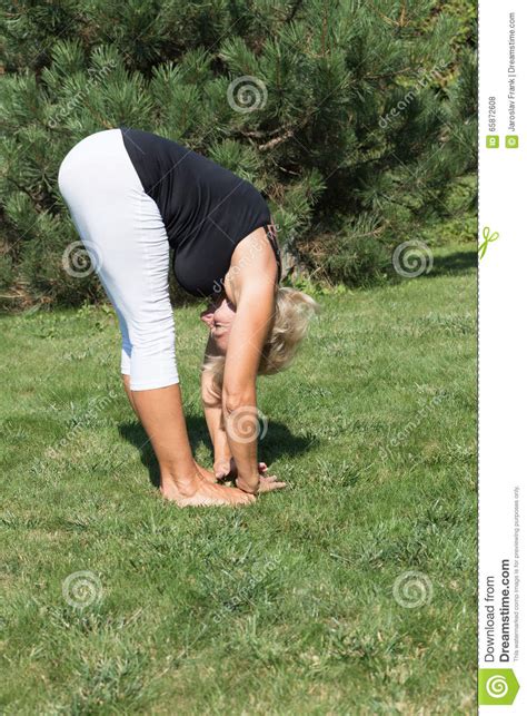 Flexible Senior Woman Is Forward Bending Outdoors Stock Photo Image
